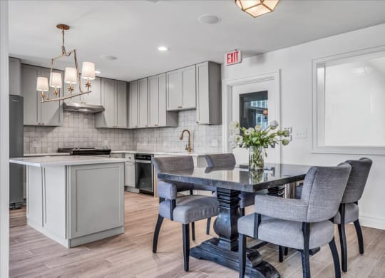 a kitchen and dining room with a table and chairs at The Vinings Apartments in Richmond, VA