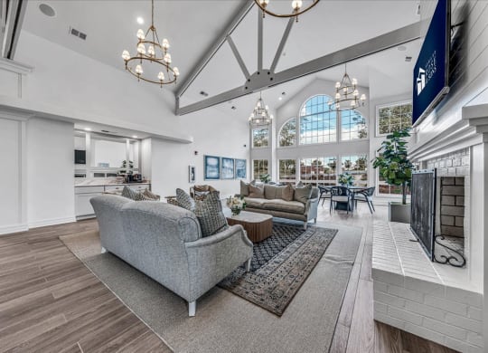 a large living room with couches and a fireplace at The Vinings Apartments in Richmond, VA