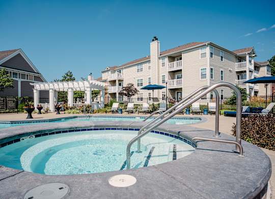 A swimming pool with a slide in front of a building.