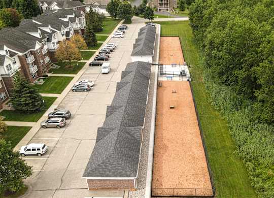 A long parking lot with cars parked in it at Towne Lakes Apartments, Grand Chute
