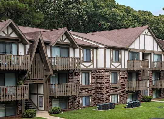 Apartment building with brown brick and white walls at Lake in the Pines, North Carolina, 28311