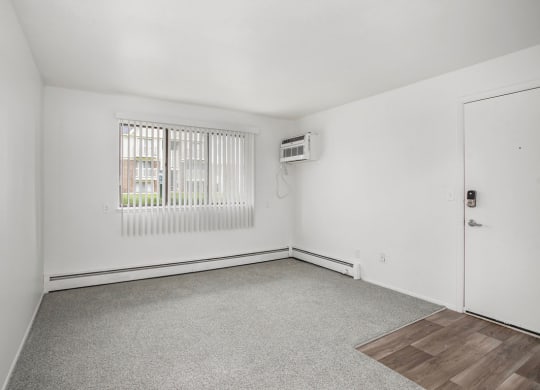 garden style living room with a window at Fairlane Apartments in Springfield, MI
