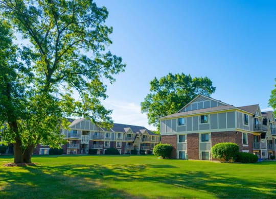 a large green lawn in front of an apartment building at Fairlane Apartments, Springfield, MI, 49037