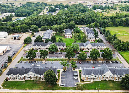 Aerial view of townhome community with parking lots at Fairlane Apartments, Springfield, 49037