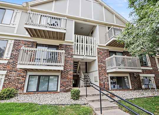 Apartment entrance with stairway and white railings at Fairlane Apartments, Michigan, 49037