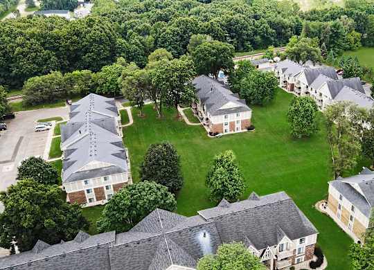 A bird's eye view of an apartment community with green lawns at Fairlane Apartments, Springfield, MI 49037