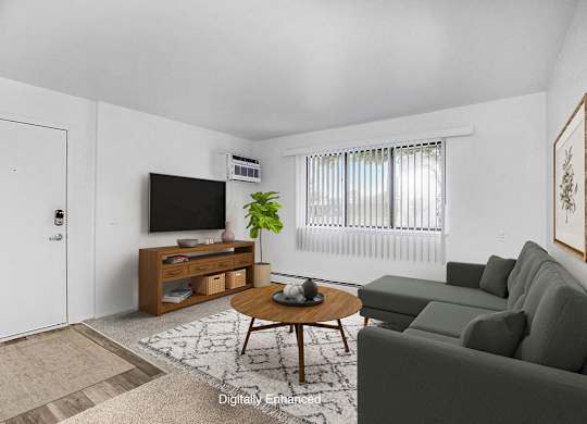 A garden style living room with carpeting at Fairlane Apartments, Springfield, Michigan