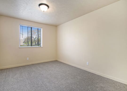 bedroom with carpet and a window at Old Farm Apartments, Elkhart, Indiana