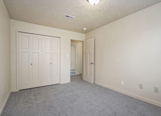 bedroom with a large closet and carpeting at Old Farm Apartments, Elkhart, Indiana