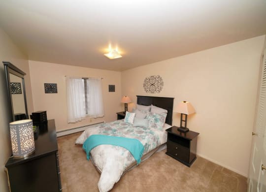 a spacious bedroom with a window at Old Farm Apartments, Elkhart, Indiana