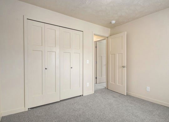 a large bedroom with closet doors at Old Farm Apartments, Elkhart, Indiana