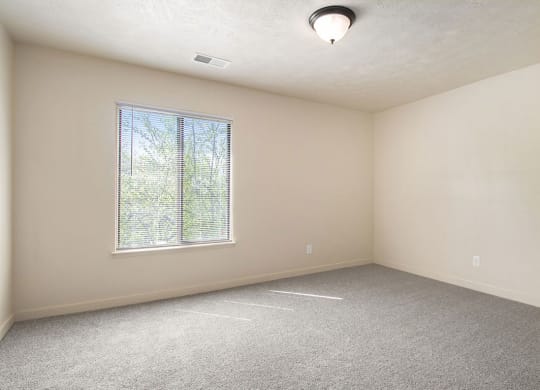 bedroom with a large window at Old Farm Apartments, Elkhart, Indiana
