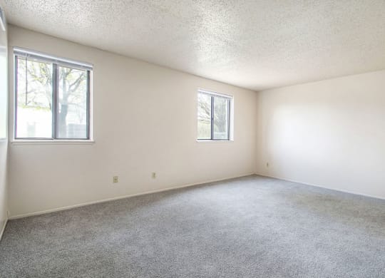 studio living room with two windows at Old Farm Apartments, Elkhart, Indiana