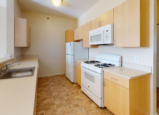 Two bedroom kitchen layout with a stove microwave and dishwasher at Fieldstream Apartment Homes, Iowa