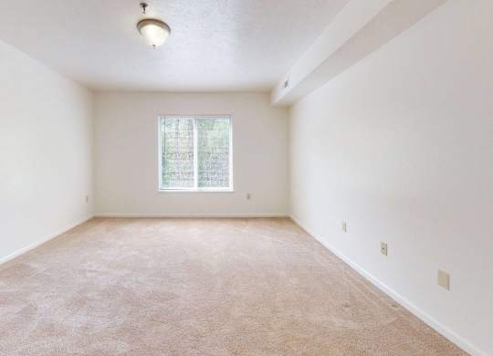 a spacious bedroom with a window at Fieldstream Apartment Homes, Iowa