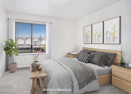 A bedroom with a bed, nightstand, and window at Foxwood and The Hermitage, Michigan