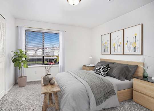 A bedroom with a large bed, a window with a view, and a potted plant at Foxwood and The Hermitage in Portage, MI