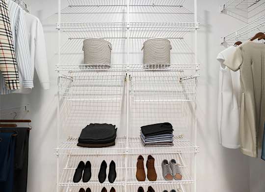 A white closet with clothes and shoes organized on shelves at Foxwood and The Hermitage in Portage, MI