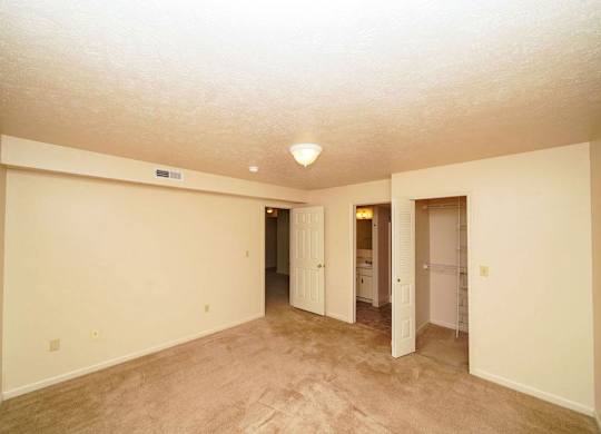 A spacious bedroom with an attached bath and walk in closet at Foxwood and The Hermitage, Portage, MI
