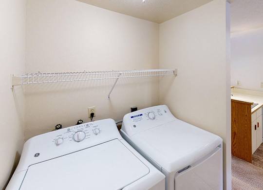 A laundry room with a washer and dryer at Foxwood and The Hermitage, Portage, MI