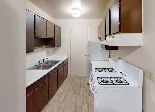 A kitchen with a gas stove at Glen Oaks Apartments, Michigan, 49442