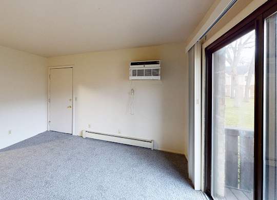 A living room with a carpeted floor at Glen Oaks Apartments, Michigan, 49442