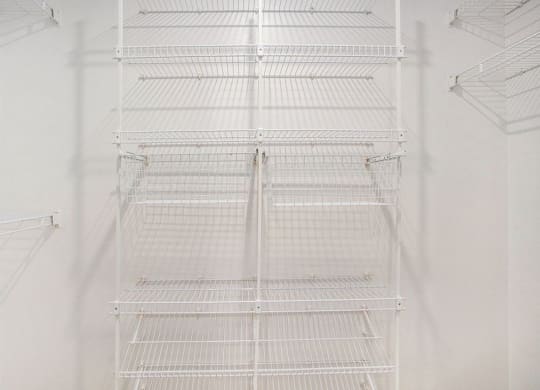 a walk in closet with wardrobe organizers at Glenn Valley Apartments in Battle Creek, MI