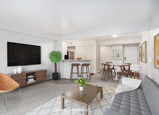 A living room with a grey sofa, wooden coffee table, and a television at Glenn Valley Apartments in Battle Creek, MI