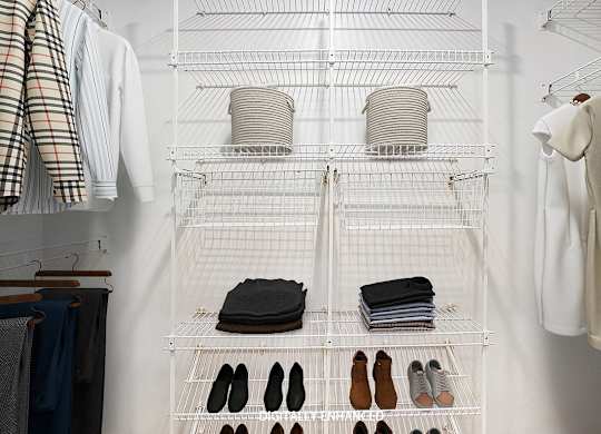 A walk in closet with wardrobe organizers at Glenn Valley Apartments in Battle Creek, MI