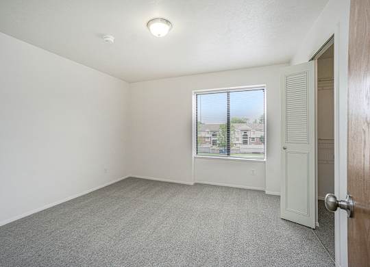 Bedroom with a closet and a window at Glenn Valley Apartments, Battle Creek