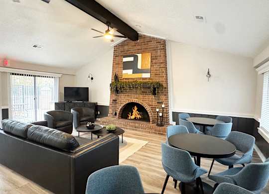 A community building with a fireplace and a TV at Granada Apartments, Jackson