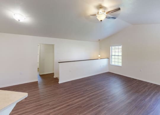 Two Bedroom Ranch Townhome living room and dining room with a cathedral ceiling and a ceiling fan at Gull Prairie/Gull Run Apartments and Townhomes, Kalamazoo, MI, 49048