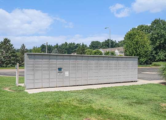 Amazon Hub package lockers surrounded by a grassy area at Gull Prairie/Gull Run Apartments and Townhomes, Kalamazoo