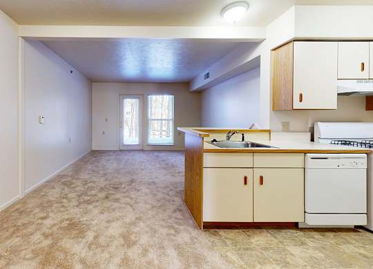 A kitchen with a sink, stove, and a dishwasher at Gull Prairie/Gull Run Apartments and Townhomes, Kalamazoo, Michigan