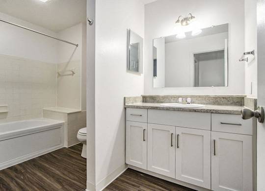 primary bathroom with white cabinets and a whirlpool tub at Gull Prairie/Gull Run Apartments and Townhomes, Kalamazoo