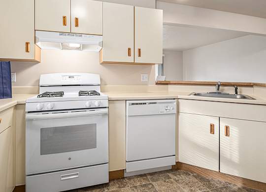 A kitchen with a white range and dishwasher at Gull Prairie/Gull Run Apartments and Townhomes, Kalamazoo, 49048