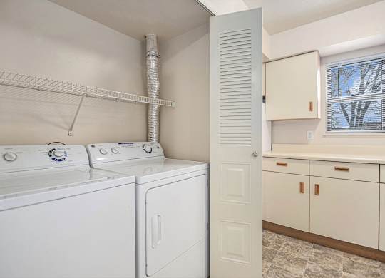 A laundry room with a washer and dryer at Gull Prairie/Gull Run Apartments and Townhomes, Kalamazoo, 49048
