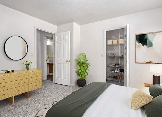 A bedroom with a bed, dresser, and a walk-in closet at Gull Prairie/Gull Run Apartments and Townhomes, Michigan, 49048