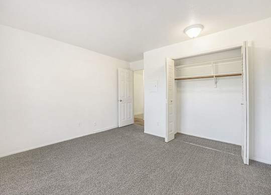 bedroom with a closet and plush carpeting at Hampton Lakes Apartments, Michigan, 49534
