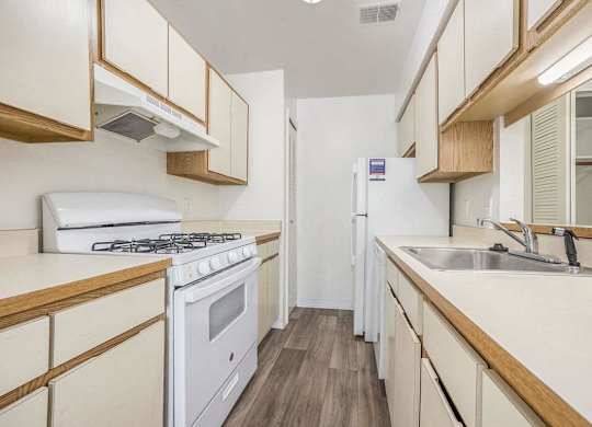 a kitchen with a gas stove, dishwasher, and a refrigerator at Hampton Lakes Apartments, Michigan, 49534