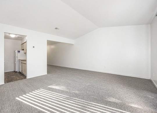 cathedral ceiling in living room with carpet at Hampton Lakes Apartments, Michigan, 49534