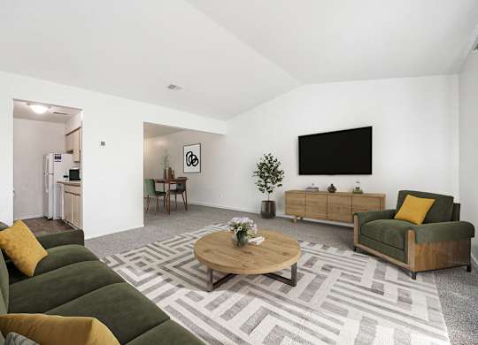 a living room with a vaulted ceiling,  couch and a coffee table at Hampton Lakes Apartments, Michigan, 49534