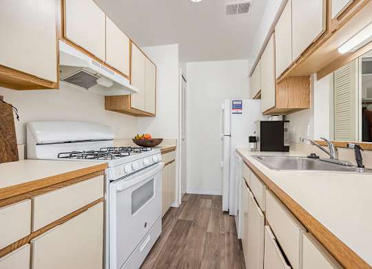 a kitchen with dishwasher and gas stove at Hampton Lakes Apartments, Michigan, 49534