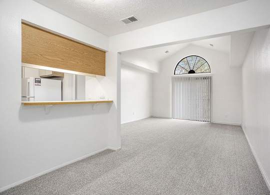 a dining and living room with a cathedral ceiling at Hampton Lakes Apartments, Michigan, 49534