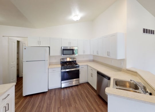 a renovated  kitchen with white cabinets and stainless steel appliances