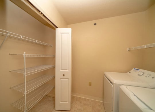 a laundry room with a closet and a washer and dryer