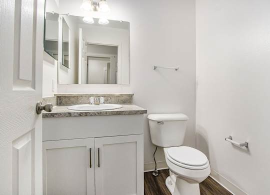 A white toilet sits in a bathroom next to a sink at Foxwood and The Hermitage, Portage, MI, 49024