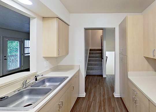 A kitchen with a microwave, stove and a sink at Foxwood and The Hermitage, Portage, MI, 49024