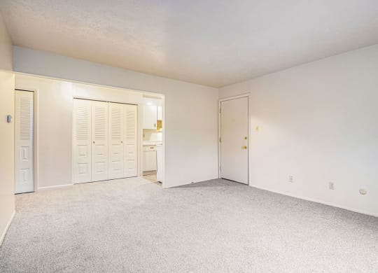 a bedroom with white walls and carpet at Hickory Village Apartments, Indiana