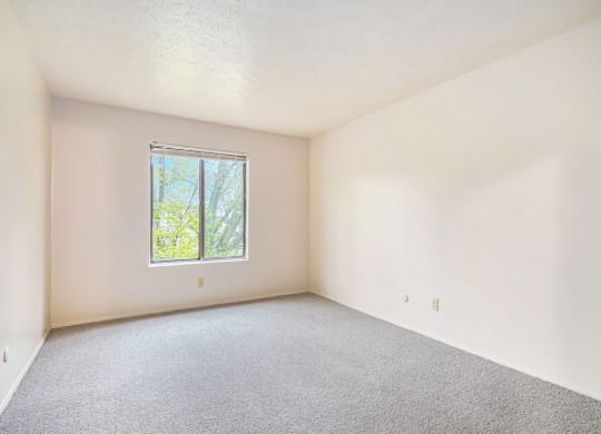 a bedroom with white walls and a window at Hickory Village Apartments, Indiana, 46545